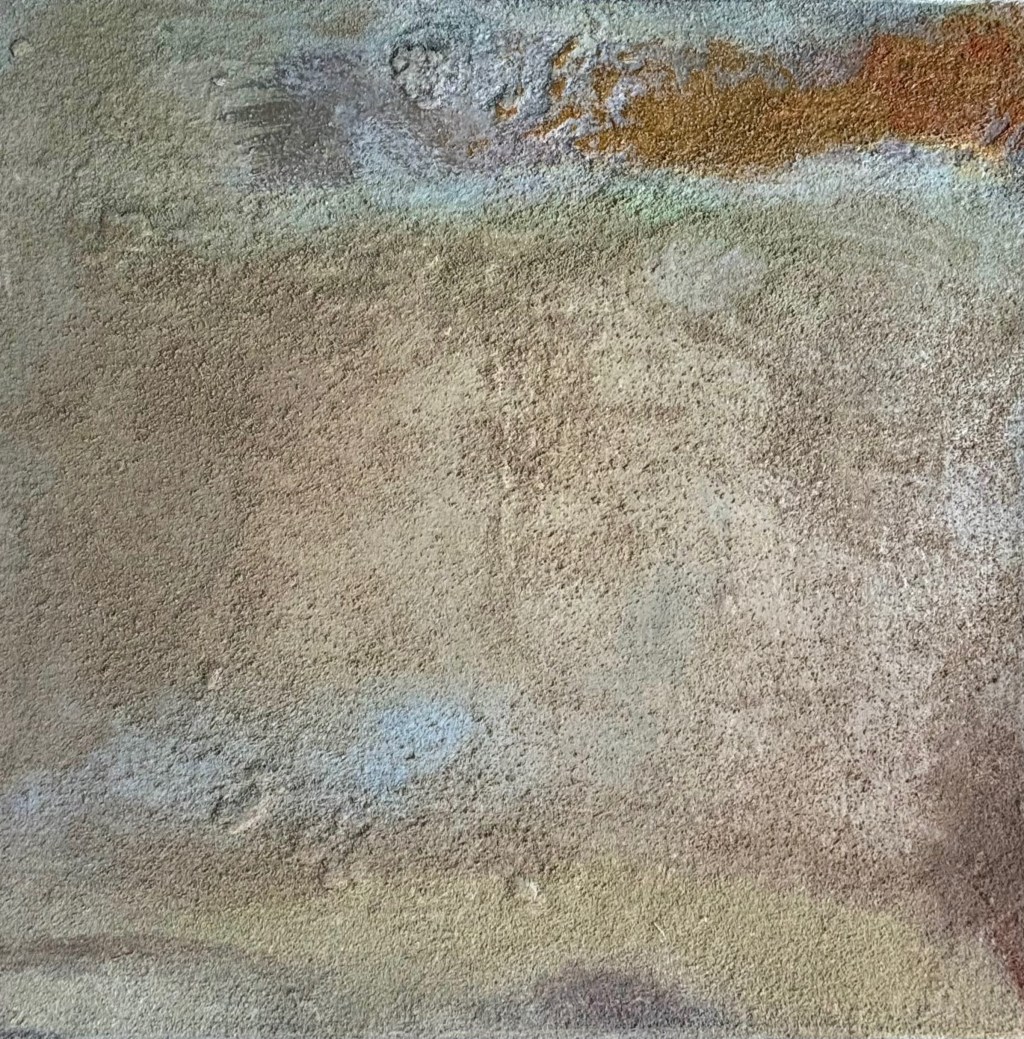 An ochre cloud in the right sky provides contrast to the landscape below.